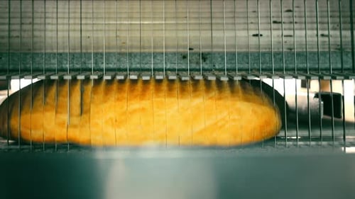 Loaf of Bread Being Sliced Automatically