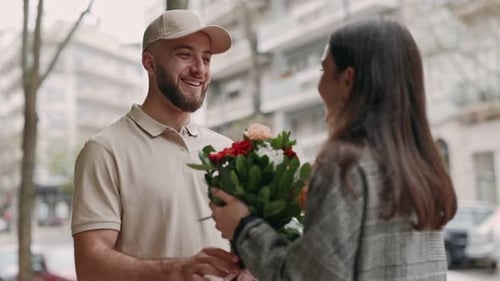 Young Man Delivers Flowers and Gift to Woman