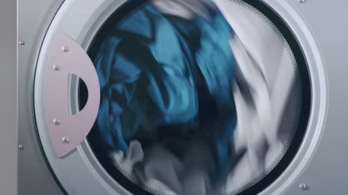 Industrial Dryer Machine Working. Closeup of Drying Clothes in Drying Machine. Close