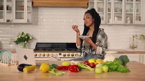 Woman Eating Healthy Food in Kitchen