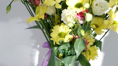 Easter Colorful Eggs in Busket on White Wooden Table