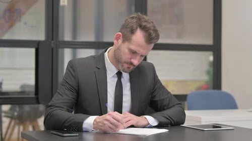Businessman Working on Documents in Office