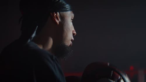 Boxer Training in Dark Gym with Gloves