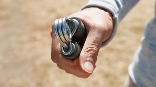 Man Strengthening Grip With Hand Grip Outdoors