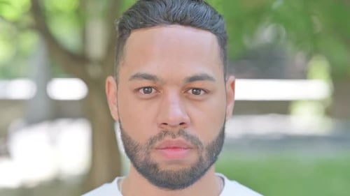 Coughing Young Woman while Sitting in Park