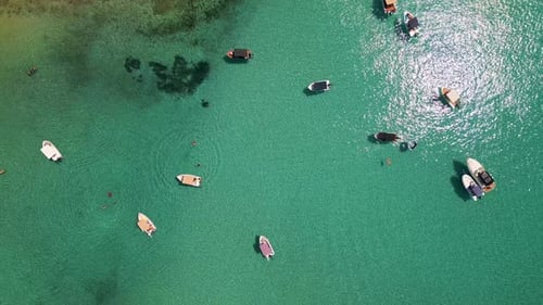 Aerial View of Boats Anchored in Shallow Turquoise Water Near the Coast Clear Sea Swimmers and
