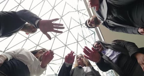 Smiling Business Team United Hands in Modern Office