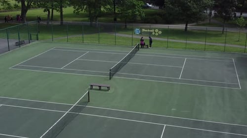 Aerial view public park tennis court surface sporting playground dolly right