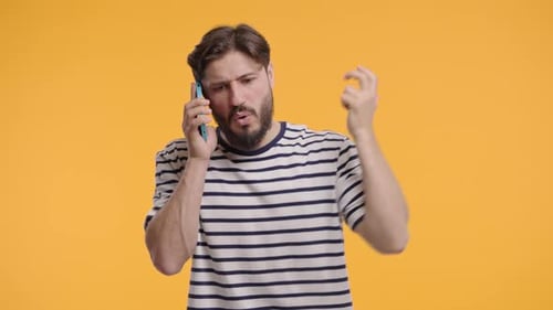 Angry Man Arguing on Phone in Studio
