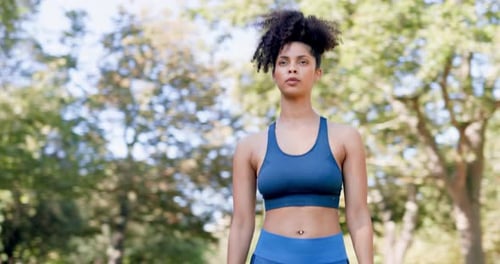 Woman Walking Through Park on Sunny Day