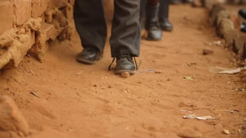 School shoes of pupils as they walk on soil in rural Africa