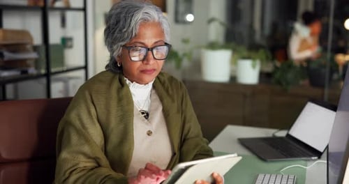 Mature woman, tablet and typing at startup, night and review with app for article deadline at media