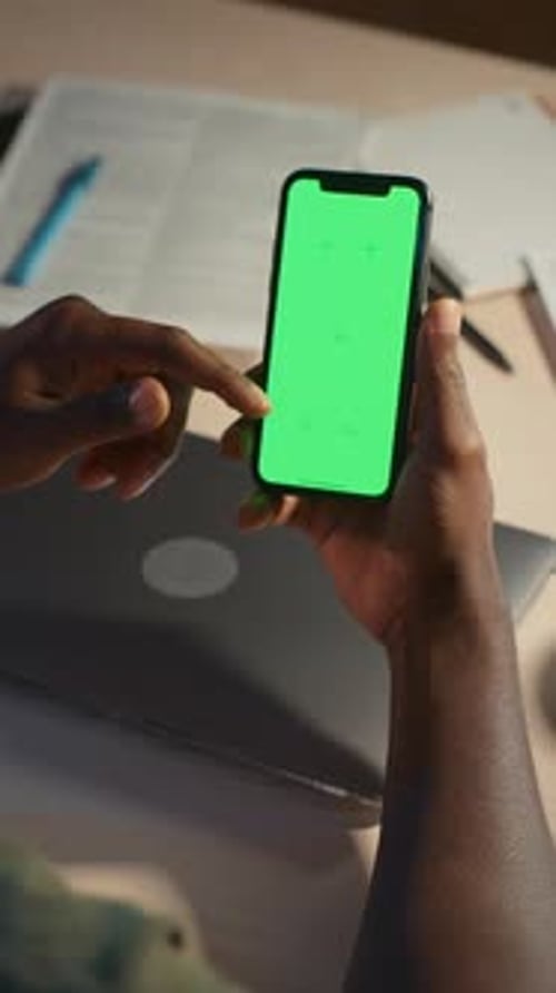 Freelancer Holding Smartphone with Chroma Key Screen at Home