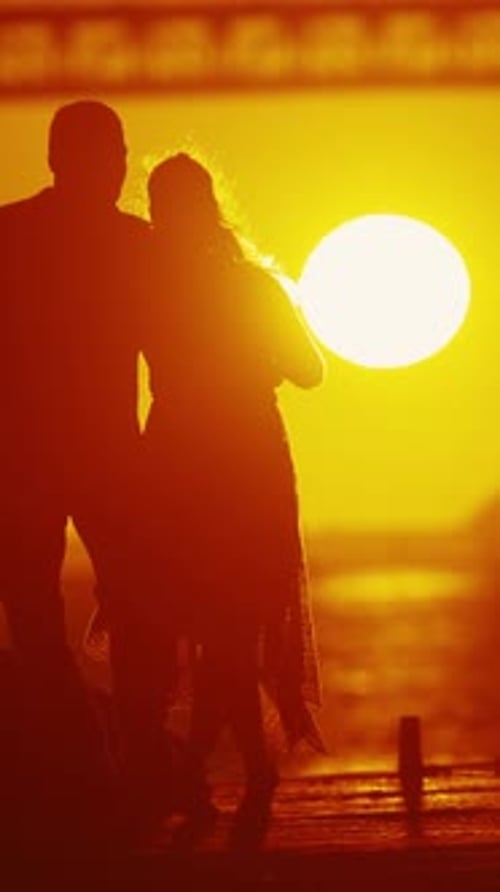 Romantic Couple Dancing at Sunset on Pier