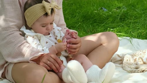 Baby in a Stylish Headband Discovers a Pacifier's Texture An Intimate Portrayal of Early Development