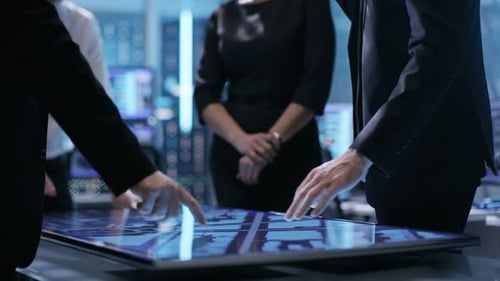 Close-up of Surveillance Agency's Agents Hands on Interactive Touchscreen Table, Tracking Dangerous