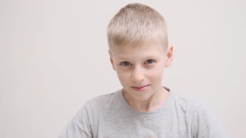 Frowning Unhappy Young Caucasian Child Looking Angry at Camera Upset Male Child Portrait with