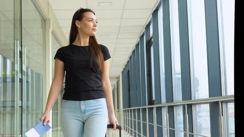 Woman Walking With Luggage At Airport Terminal Female Holding Passport With Tickets And Carrying