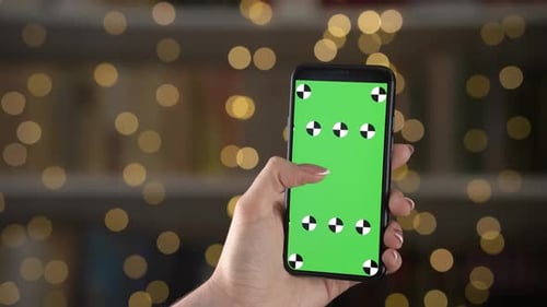 Woman Hand Holds the Phone Mockup Vertically and Swipe Finger to Left on Green Screen with Markers