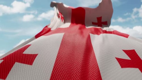 Realistic Waving Flag of Georgia Against Blue Sky