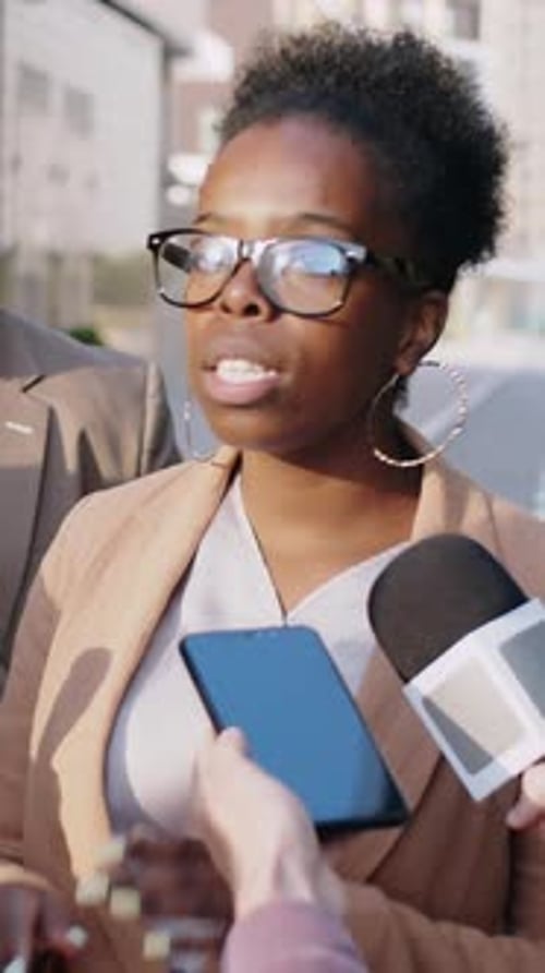 Woman Giving Press Interview on City Street