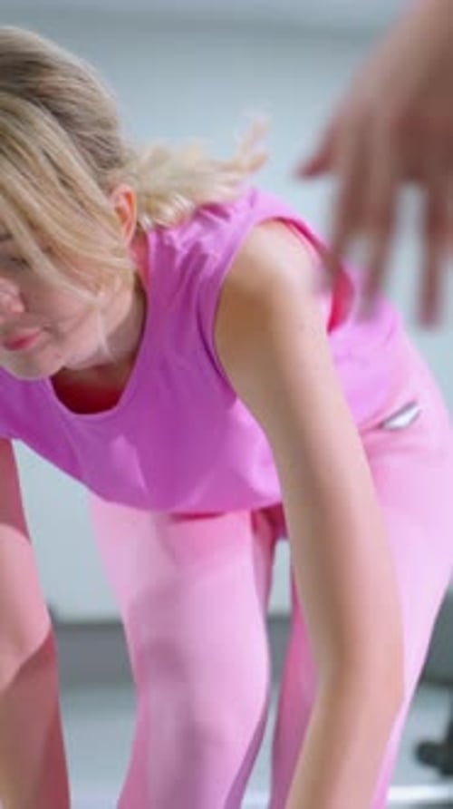 Woman Adjusting Foam Roller in Gym with Reflective Mirror View