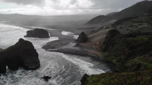 Powerful Ocean Waves Crashing on Black Sand Beach on Cloudy Day