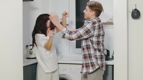 A Heated Argument Escalates Into a Physical Fight Between a Multiracial Couple in a Modern Kitchen