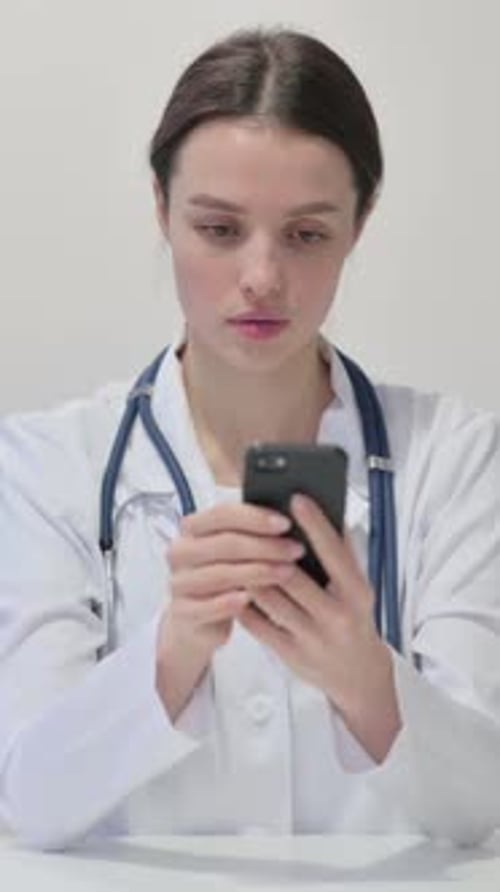 Female Doctor Using Smartphone in Hospital Close Up