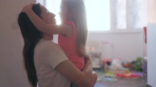 Loving Mother Hugging Child in Bright Indoor Setting