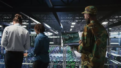 Soldier in Server Room Uses Geospatial Data to Support Emergency Operations