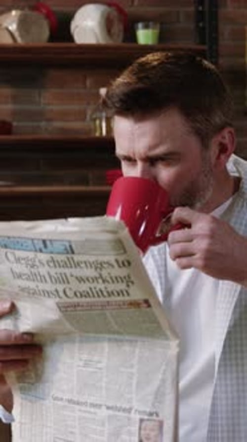 A Man Enjoying His Coffee While Reading the News in the Comfort of His Home Environment