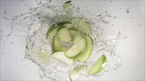 Super Slow Motion of Explosion Green Apple and Burst Water and Slices