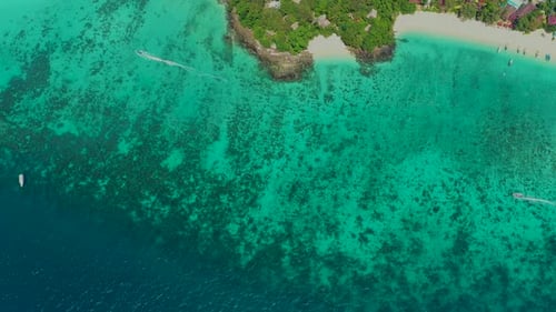 Aerial view of iconic tropical turquoise water Pileh Lagoon surrounded by limestone cliffs, Phi Phi