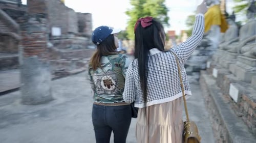 Thai Girls Sightseeing Around Wat Yai Chai Mongkhon Temple Walking By Buddha Stony Statues in