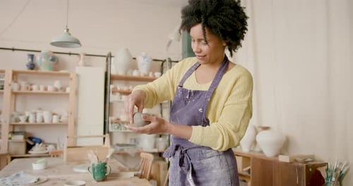 Female Artist Crafting in Pottery studio with Creative focus.