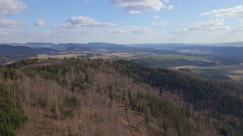 Drone Flight Over Mountains Covered with Forest and Valleys