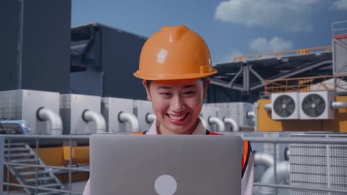 Close Up Of Asian Female Engineer Working On A Laptop On Rooftop HVAC
