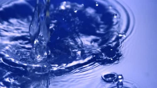 Water poured into the water basin macro shot