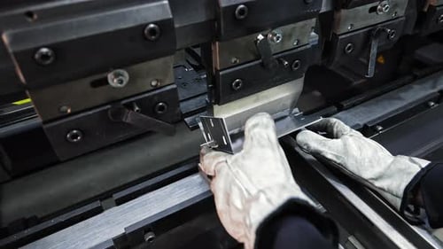 Worker Operating Press Brake to Bend Sheet Metal Component Precision Metal Forming with Gloves in