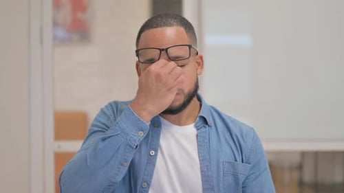 Portrait of African Man with Headache in Office