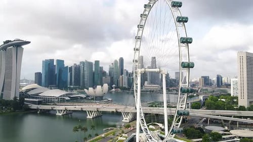Aerial drone shot of Marina Bay futuristic modern city skyline with Singapore Flyer