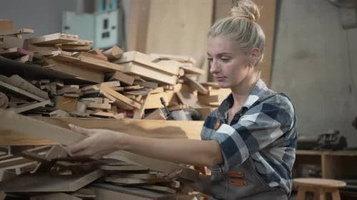 Carpenter is working together at workshop.