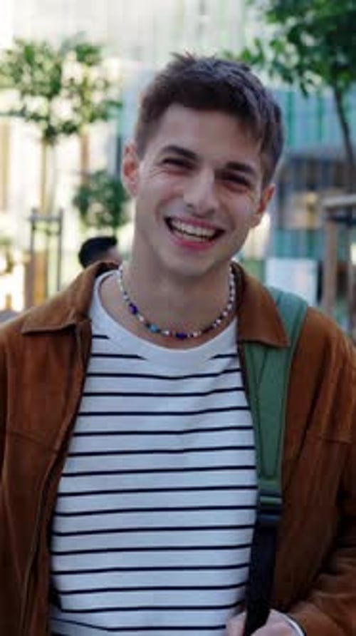 Young Spanish Student Man Looking at Camera Standing at College Campus