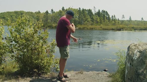 Daytime Defense Man Spraying Mosquito Repellent By the Lake
