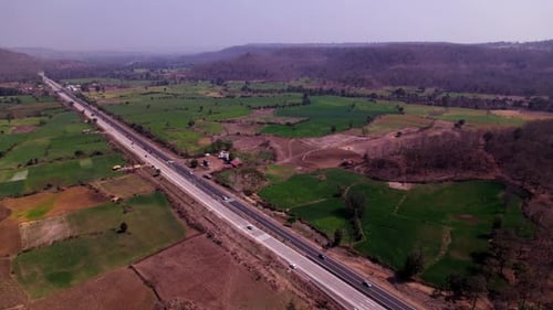 national highway with farming lands and hill mountain at siluwa, madhya pradesh, india. day time, pu
