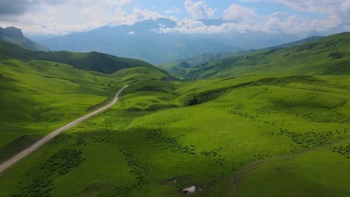 Actoprak's Green Mountain Pass Aerial View Day's Charm Cloud Embrace Majestic Mountain Pass Scenic