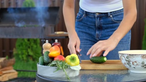 Unrecognizable Woman Slicing Fresh Cucumber For Salad