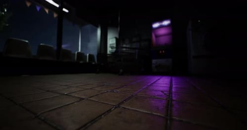 Mysterious Empty Room Illuminated By Purple Light at Night