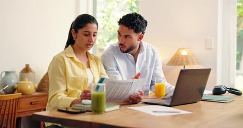 Young Couple Discussing Finances at Home Office